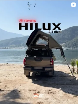 Toyota Hilux 2.4 diesel with a rooftop tent on the beach